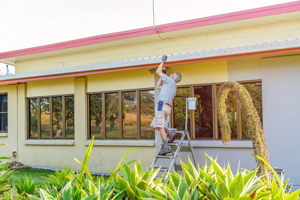 Senior man is painting his new house