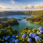 A panoramic view of the twin crater lakes of Sete Cidades in the Azores, featuring one blue and one green lake surrounded by lush green hill