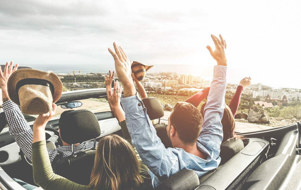Millennials driving a convertible on the west coast of USA